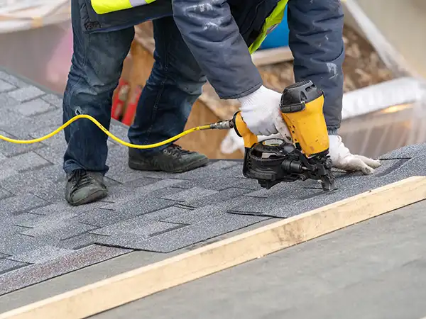 Roofer installing new shingles